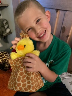 CCSD student holding stuffed animal brought to him by his teacher.