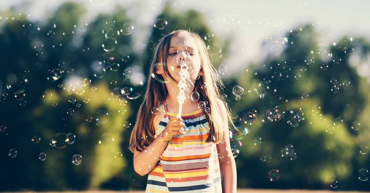 Girl blowing bubbles.